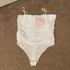 Kittenish white ruffled bodysuit